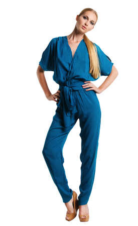 Portrait of the beautiful blonde girl in long blue overallsの写真素材