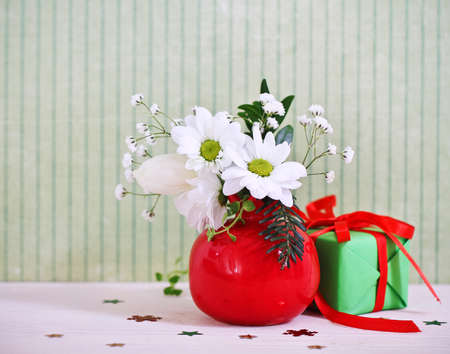 Bouquet of winter flowers with present decorated with ribbonの写真素材