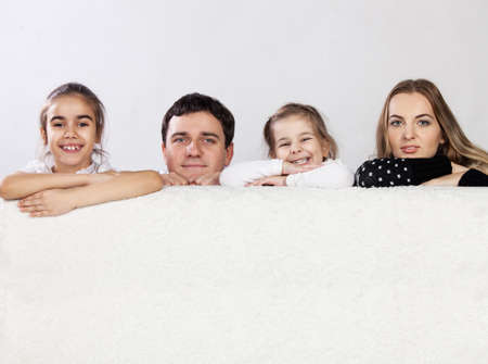 Happy young family with two childrenの写真素材