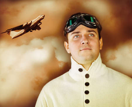 Young man in retro style clothes wearing old-fashioned pilot glasses. Sepia portraitの写真素材