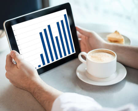 Man holding tablet computer with graphic in cafe