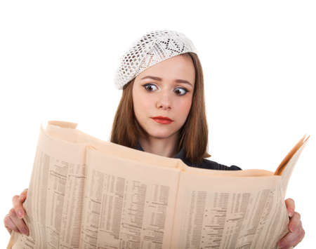 Young cute brunette girl in parisian style look in shock at the newspaperの写真素材