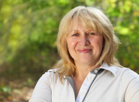 Middle aged woman looking at camera with happy smile Middle aged woman looking at camera with happy smile