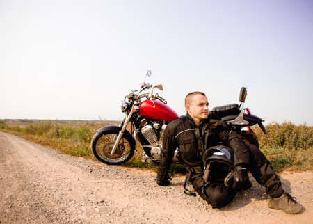 Biker on the country road against the skyの写真素材