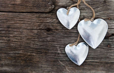 Metal hearts on wooden background. Valentine`s day conceptの写真素材