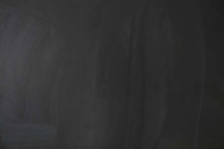 Blackboard texture background. Empty blank black chalkboard with chalk tracesの写真素材