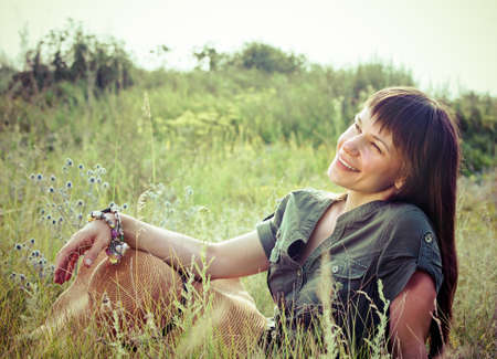 Smiling brunette woman in sunny summer dayの写真素材