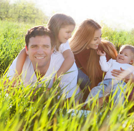 Happy young family with two children outdoors