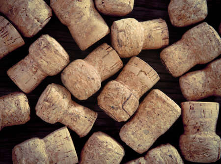 Dated wine bottle corks on the wooden background. Close up