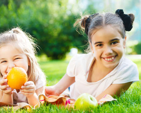 Happy little girls in the park in summer dayの写真素材