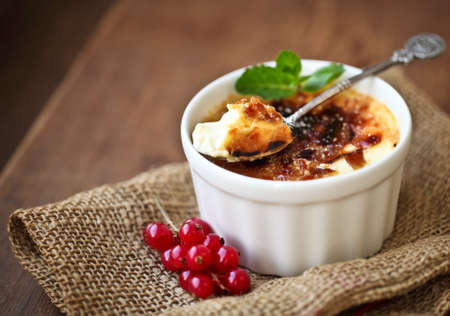 Creme brulee (cream brulee, burnt cream) with red currant and mintの写真素材