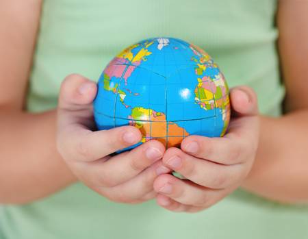 Child holding little globe in his handの写真素材