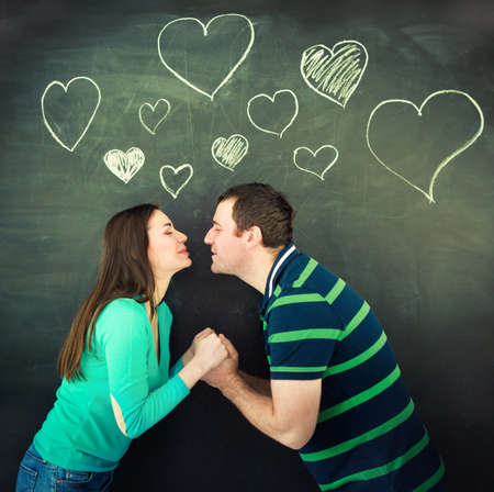 Young couple in love. Chalk drawing on dark background