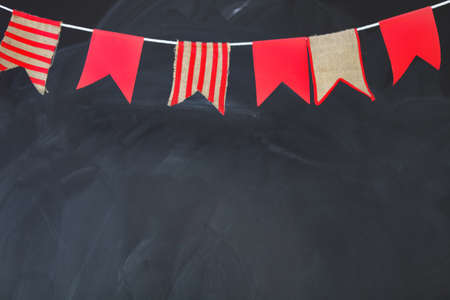 Blackboard texture background. Empty blank black chalkboard with chalk traces decorated by flagsの写真素材