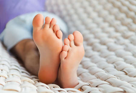 Lazy time. Feets in a hammock on a summer dayの写真素材