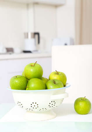 Green apples on the  white luxurious kitchen の写真素材