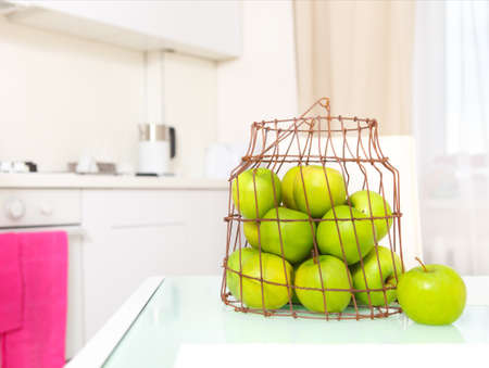 Green apples on the  white luxurious kitchen の写真素材