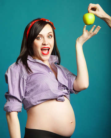 Happy young funny pregnant woman in pin up styleの写真素材