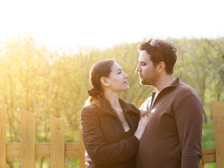 Happy smiling couple in the autumn garden. Sunsetの写真素材