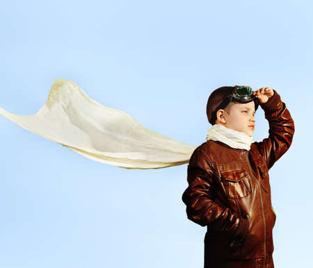 Little boy dreaming of becoming a pilot in retro style uniformの写真素材