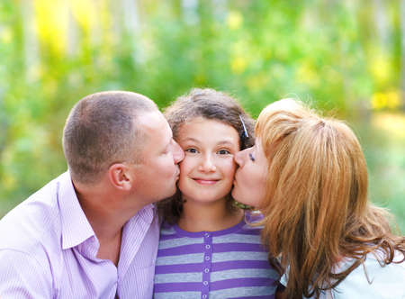 Happy young family with daughter on autumn picnicの写真素材