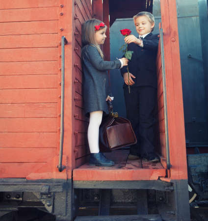 little boy and little girl on the retro trainの写真素材