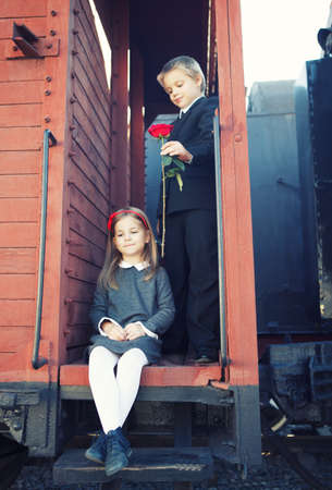 little boy and little girl on the retro trainの写真素材