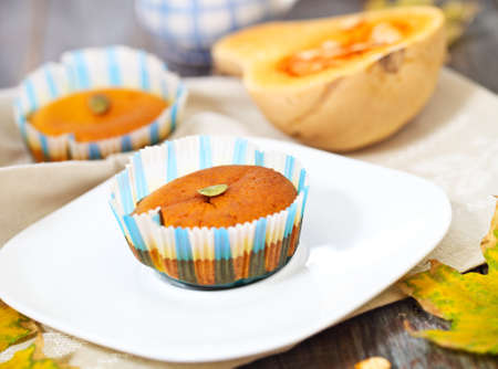 Pumpkin muffins with seeds and pumpkin on the wooden の写真素材