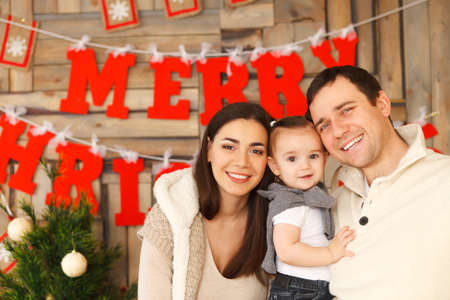 Happy smiling family with near the Christmas backgroundの写真素材
