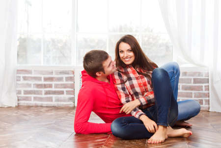 Couple in love at home relaxing on the floorの写真素材