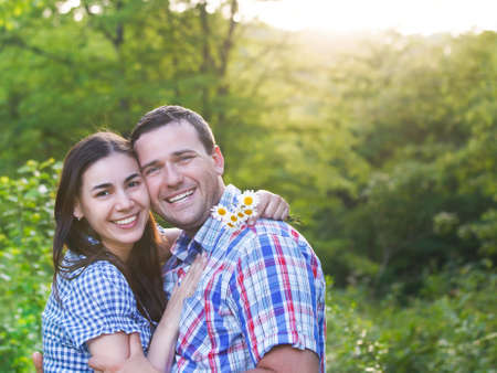 Young happy couple in love in spring day. Outdoors portraitの写真素材