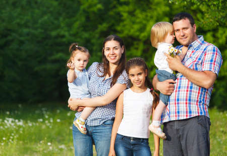 Happy young family with children in the spring forest