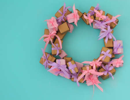 Wreath from little presents hanging on the  blue wall with copy spaceの写真素材