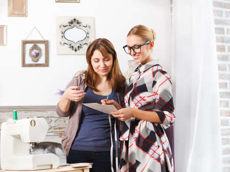 Designer working with client in fashion atelier