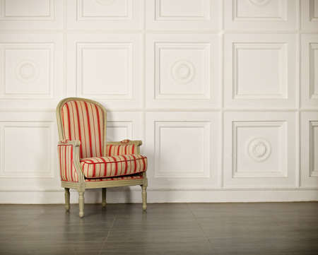 One classic armchair against a white wall and floor. Copy spaceの写真素材