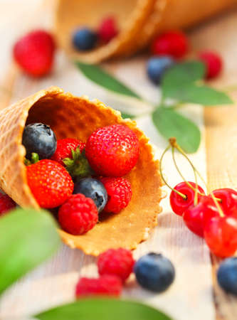 Wafer cups with strawberry, cherry, raspberry and blueberry. Dessertの写真素材