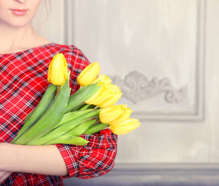 Close up of beautiful romantic woman with blond hair with tulip bouquetの写真素材
