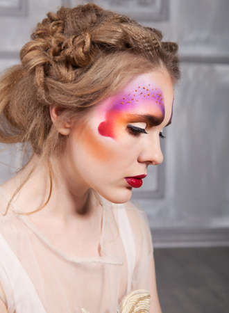 Portrait of a young model beautiful woman with perfect butterfly make up and hairstyle. Clouse up