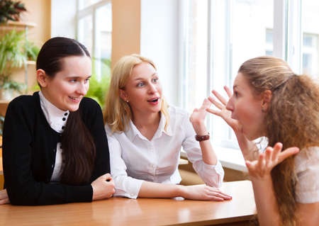 Group of student girls during a brake between classes - chatting and having fun 