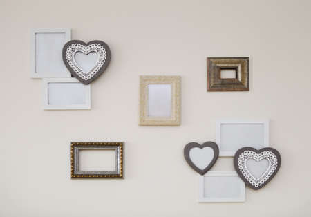 Set of white and golden vintage antique frames on th light wall