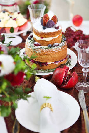 Dessert table for a wedding. Cake, cupcakes, sweetness and flowers