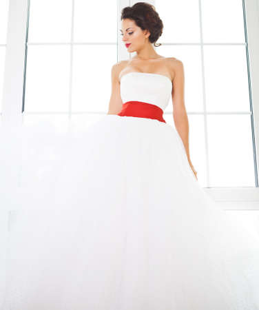 Portrait of beautiful happy bride wearing white wedding dressの写真素材