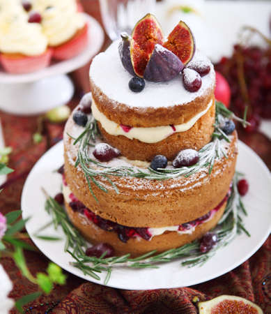 Dessert table for a wedding. Cake, cupcakes, sweetness, fruits and flowers. Close upの写真素材