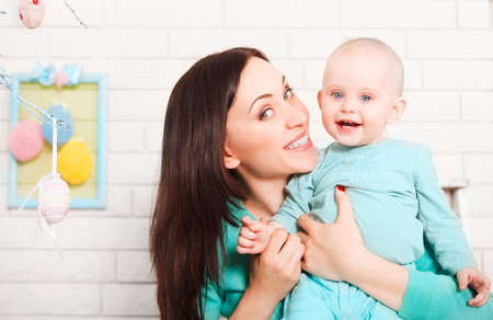 Happy mother and baby spending time together. Easter time
