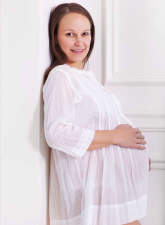 Portrait of the young smiling pregnant womanの写真素材