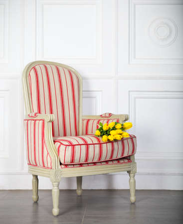 One classic armchair against a white wall and floor. Copy spaceの写真素材