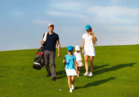 Family of golf players walking  at the courseの写真素材