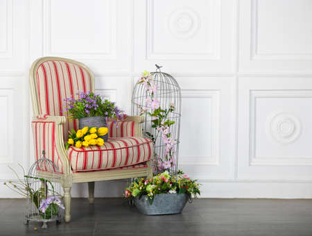 One classic armchair against a white wall and floor. Copy space