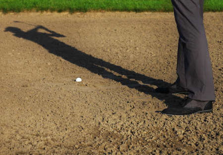 Athletic young man playing golf, golfer hitting fairway shot, swinging club