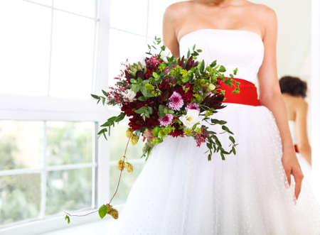 Unusual wedding bouquet with succulent flowers in retro style at hands of a brideの写真素材